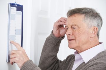 Confused Senior Man With Dementia Looking At Wall