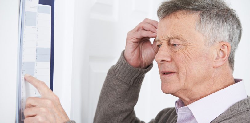 Confused Senior Man With Dementia Looking At Wall