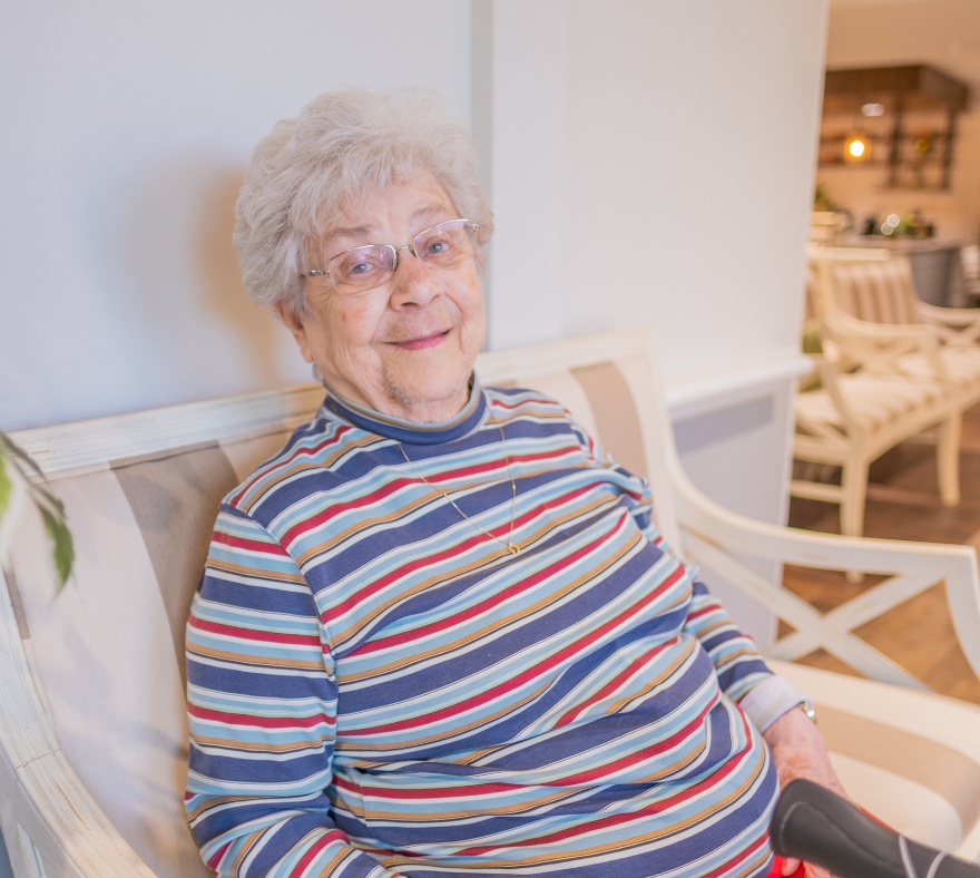 active assisted living resident sitting and smiling for the camera at omaha's parsons house