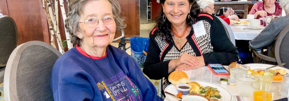 two women eating breakfast at an assisted living facility in Omaha.